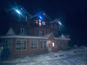 a building with blue lights on top of it at night at Cottage 12 Months in Vorokhta