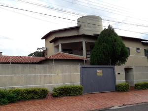 une maison avec une porte grise devant elle dans l'établissement Hostel DS, à Campo Grande