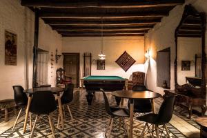 a room with two tables and a pool table at Casona El Resguardo in Río Blanco