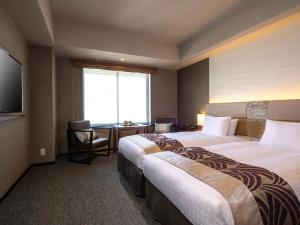 Tempat tidur dalam kamar di Tokyu Stay Kyoto Sakaiza Shijo Kawaramachi
