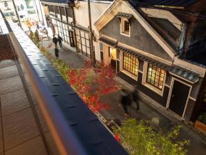 an overhead view of a building and a garden with red flowers at Tokyu Stay Kyoto Sakaiza Shijo Kawaramachi in Kyoto