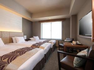 Tempat tidur dalam kamar di Tokyu Stay Kyoto Sakaiza Shijo Kawaramachi