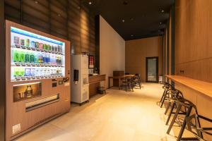 a restaurant with a bar and a large screen at Tokyu Stay Hakata in Fukuoka