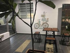 a plant in a room with a table and chairs at BELLE VILLE in Muar