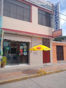 a yellow umbrella sitting in front of a store at Hospedaje Golden Inn in Camaná