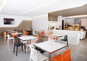 a dining room with tables and chairs in a restaurant at Royal Hotel Group- Central Park Branch in Kaohsiung