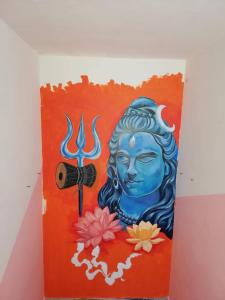 a painting of a statue with a camera on a wall at Om Trance Hostel in Jaipur