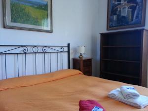 a bedroom with a bed with two towels on it at A Due Passi Dal Centro Bed and Breakfast in Pisa