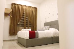 a bedroom with a large bed with a window at BELLE VILLE in Muar