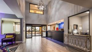 a living room with a chandelier and a hallway at Best Western Executive Inn Corsicana in Corsicana