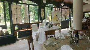 a dining room with a table and chairs and windows at Balneum Boutique Hotel & B&B in Bagno di Romagna