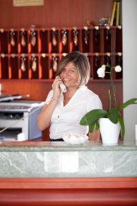 a woman is talking on a cell phone at Hotel Belvedere in Martinsicuro +39 photos