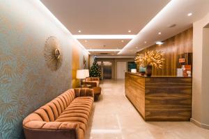 a lobby with couches and a bar in a hotel at Rossio Boutique Hotel in Lisbon