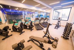 a gym with a bunch of treadmills and machines at Pentahouse Mountain Belle Vue in Poiana Brasov