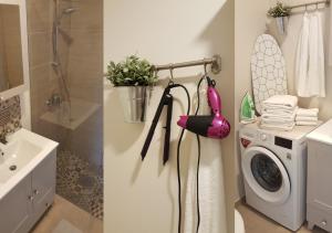 a bathroom with a washing machine and a sink at Kuressaare Family and Garden Apartments in Kuressaare