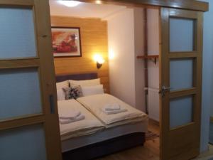 a bedroom with a bunk bed with a door open at Apartments Vila Zubović in Kopaonik