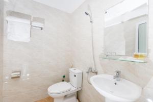 a white bathroom with a toilet and a sink at HUNG GIA HOTEL in Quy Nhon +28 photos
