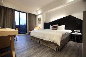 Postel nebo postele na pokoji v ubytování Hai Sheng Wei B&B