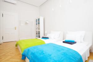 a white bedroom with two beds in it at Apartment Marmonaut in Split