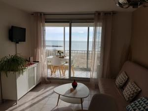 a living room with a view of the ocean at Appartement T2 valras plage in Valras-Plage