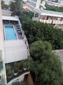 an overhead view of a building with a swimming pool and plants at Oasis Hotel in Alger