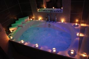 a large bath tub with lights in a bathroom at Greenvale Hotel in Cookstown