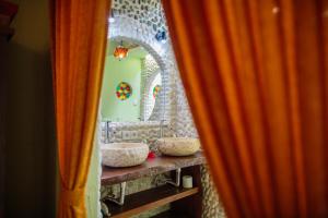 a bathroom with two sinks in front of a mirror at Bali Bohemia Huts in Ubud