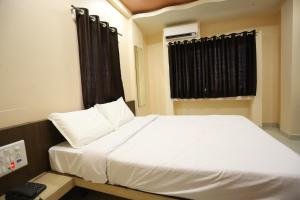 Postel nebo postele na pokoji v ubytování Hotel Pride Executive