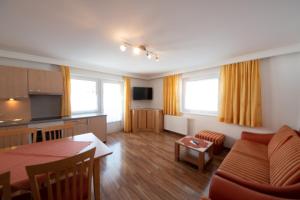 a living room with a kitchen and a dining room at Amontanara in Nauders