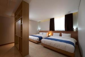 Ένα ή περισσότερα κρεβάτια σε δωμάτιο στο Benikea Hotel Yangsan