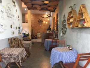 a dining room with two tables and chairs in a restaurant at Dolphin Home in Dong Hoi