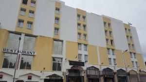 a building on the corner of a street at Hotel El Biar in Alger