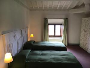 Rúm í herbergi á Al Palazzaccio