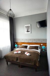 a bedroom with two beds and a flat screen tv at Expolis Residence - City Center MTP TARGI- Reception 24h in Poznań