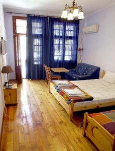 a bedroom with a bed and a table and a couch at Interhost Guest rooms and apartments in Sofia