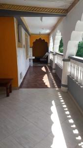 a hallway of a building with yellow walls and a table at Villa tuffah in Watamu
