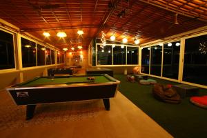 a large room with a pool table in it at Acons Palm Beach in Alibaug