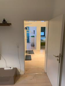 un corridoio con una porta aperta su una camera di 5min City Zentral - Wohnen am Werdersee Neustadt a Brema