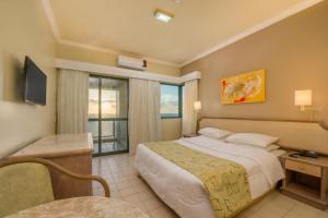 a hotel room with a large bed and a window at Costa Mar Recife Hotel by Atlantica in Recife