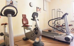 a gym with two tread machines and a treadmill at Hotel Corallo in Gatteo a Mare