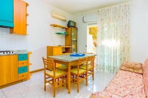 a kitchen and dining room with a table and a couch at Venezuela in Bibione