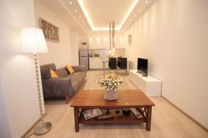 a living room with a couch and a table at Superior Apartments in Tbilisi City