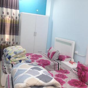 a bedroom with two twin beds and a mirror at Sweet Home Flat 2 in Hurghada