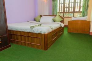 A bed or beds in a room at Swastik Guest House
