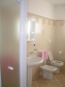 a bathroom with a sink and a toilet at Ariabuona in Moneglia +46 photos
