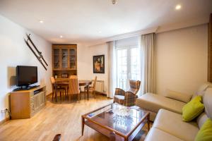 a living room with a couch and a table at Bed and Snow Apartments in Sierra Nevada