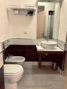 a bathroom with a toilet and a sink at Brezza Marina in Sapri