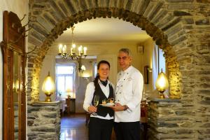 a man and a woman standing in an archway at Moselhotel Ludwigs in Köwerich