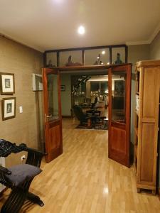 a living room with glass doors and a wooden floor at Hostería Patagonia Jarke in Ushuaia
