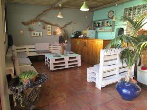 a living room with white furniture and potted plants at Herdade Do Pessegueiro in Porto Covo